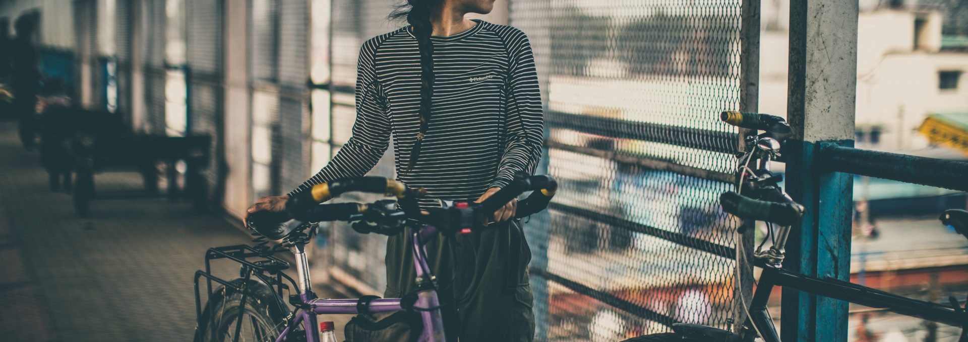 woman holding purple city bicycle