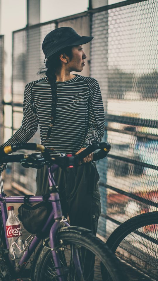 woman holding purple city bicycle